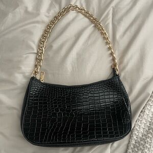 Black and gold shoulder bag in mint condition.